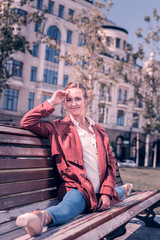 My skills. Joyful nice woman smiling to you while doing the splits on the bench © Viacheslav Yakobchuk