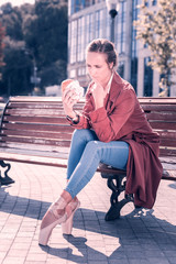 Eat or not to eat. Pleasant hungry ballerina looking at the hamburger while being on a diet © Viacheslav Yakobchuk