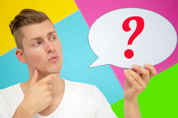 blond man holding a speech bubble with a question mark