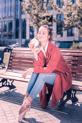So delicious. Positive young ballerina enjoying a hamburger while sitting on the bench © Viacheslav Yakobchuk