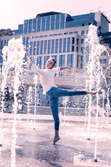 Freshness of water. Attractive young woman smiling while enjoying dancing in the fountain © Viacheslav Yakobchuk