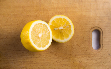 Sliced fresh lemon on wood surface. Close up.