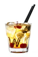 Yellow cocktail with ice cubes and cherries