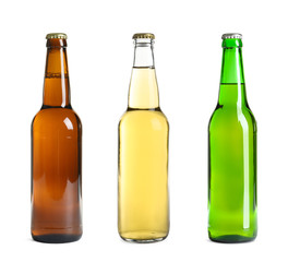 Set with different beer bottles on white background