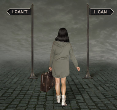 The woman with a old suitcase is at a crossroads with two signs  I can and I can't.  Concept.