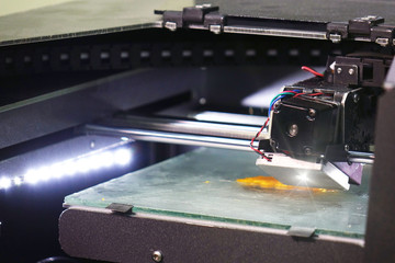 3D laser printer. Print parts on a 3D printer with a plastic figure .