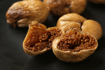 Delicious dried figs on black background, closeup. Organic snack