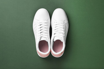 Pair of sneakers on color background, flat lay