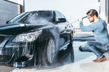 Car washing. Cleaning car using high pressure water.