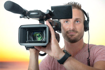man with professional camcorder and headphones