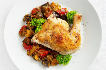 chicken tabaka garnished with ajapsandali and decorated with parsley