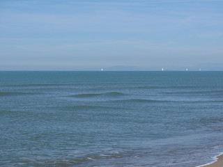 Sailboats sailing mediterranean calm sea water on the horizon