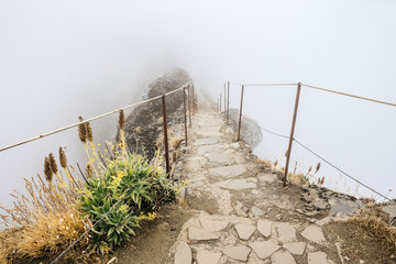 A  journey to unknown. Hiking trail in between clouds. Pico do Arieiro, at 1,818 m high, is Madeira...