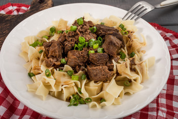 Stewed beef with tagliatelle pasta.
