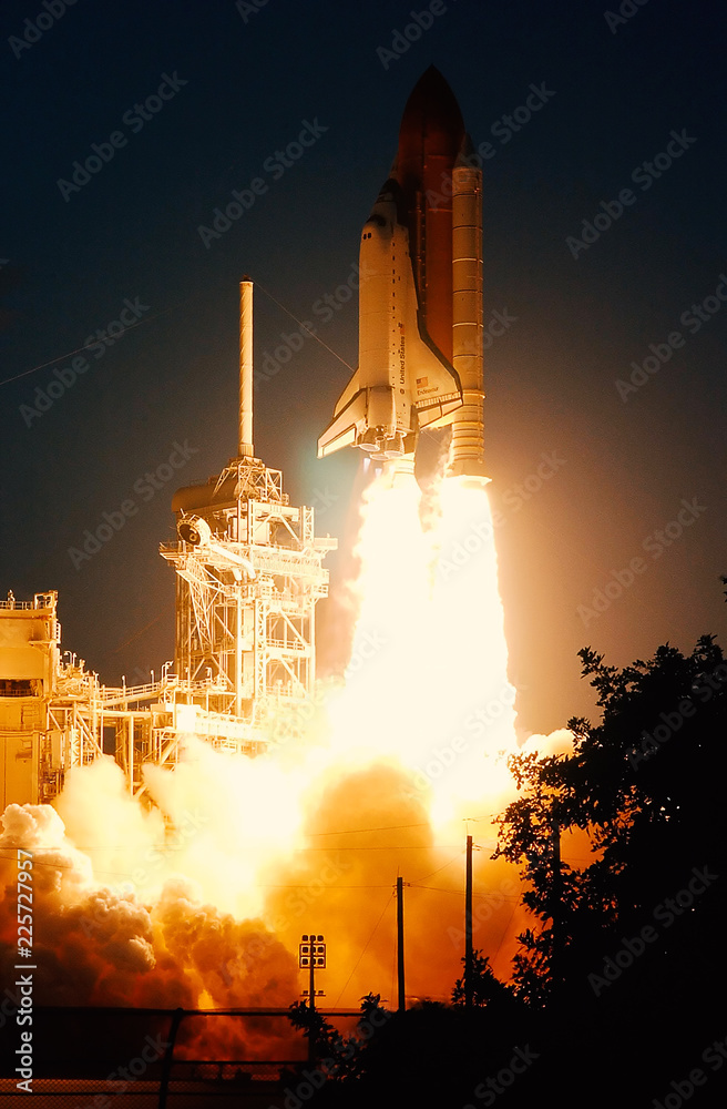 Wall mural launch of the spaceship from the spaceport at night. flight of space shuttle in clouds of smoke. som