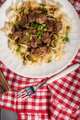 Stewed beef with tagliatelle pasta.