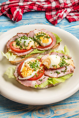 Sandwich with tomatoes, eggs and lettuce.