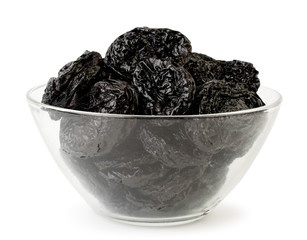 Prunes in a glass plate on a white, isolated.