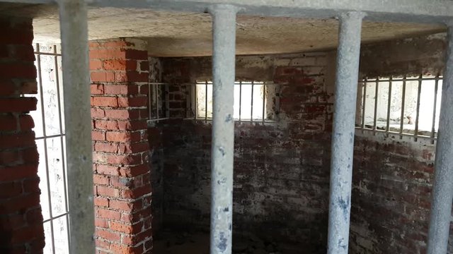 Looking through bars into a World War II coastal defences building in Fairbourne, Wales UK.