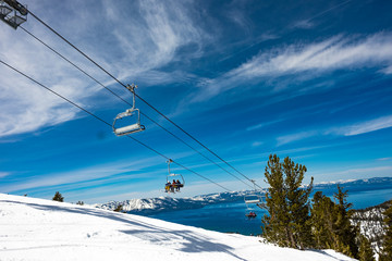 Fototapeta Lake Tahoe from Heavenly Resort - skiing - looking at ski lift with lake in background - space for text top right obraz