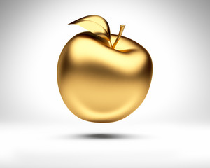 Goldener Apfel vor Weiß