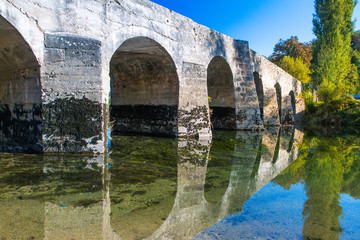      Croatia, river Dobra and old stone bridge in Novigrad, Karlovac county 