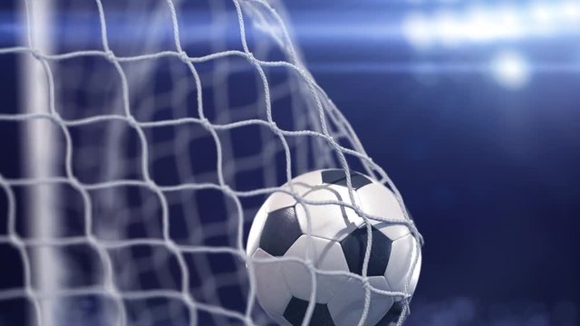 Beautiful soccer ball flies into net. Projector of light on a background. The movement at the beginning is accelerated then slowly