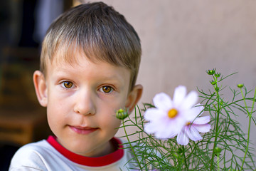 boy with brown eyes in flowers