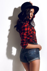 Brunette model, fashion model on a white background, model in a plaid shirt