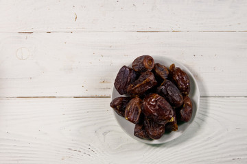 Dried dates fruit on white wooden table. Top view