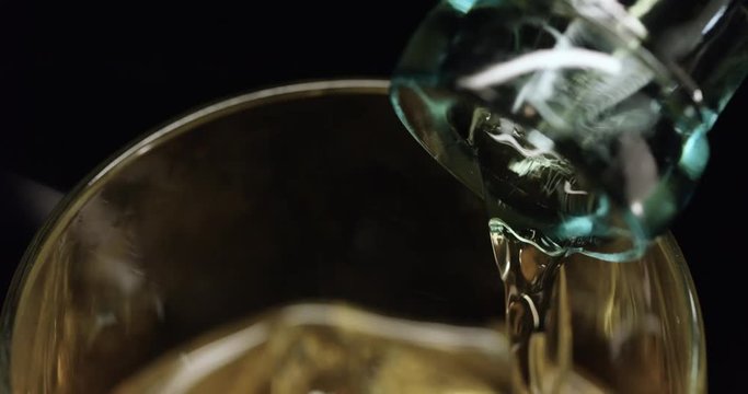 Loop of Extreme close up, scotch poured in glass