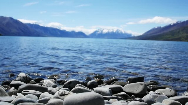Loop of Low angle, scenic lake in New Zealand with mountains in background