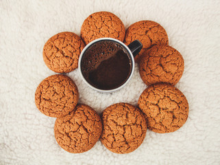 New Year and Christmas. Serpentine and garlands. Ginger and oatmeal cookies. New Year sweets. White background. Hot coffe in dark cup.