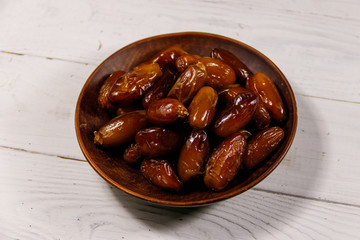 Dried dates fruit on white wooden table