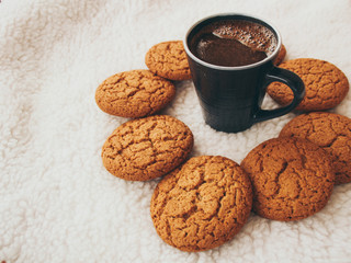 New Year and Christmas. Serpentine and garlands. Ginger and oatmeal cookies. New Year sweets. White background. Hot coffe in dark cup.