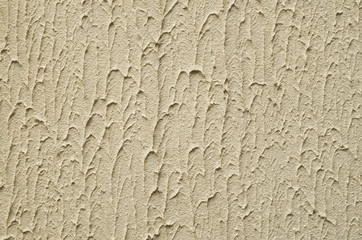 New decorative yellow plaster on wall closeup