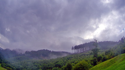 Fototapeta na wymiar Clouds and fog over Carpathian mountains