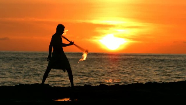 Loop of Fire knife dancer performs at sunset