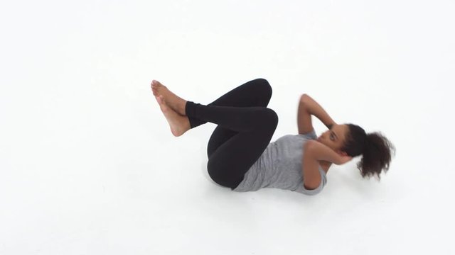 Loop of Young African American woman doing crunches and exercising