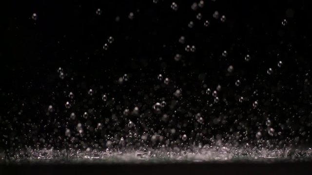 Loop of Water droplets, slow motion black background