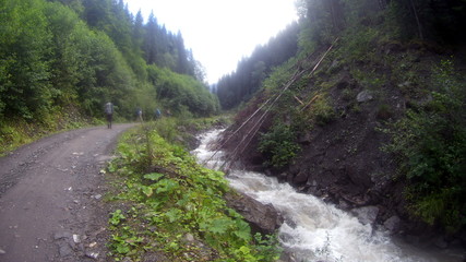 Fototapeta na wymiar Mountain river and waterfall in mountain forest