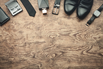 Men's accessories on wooden background.