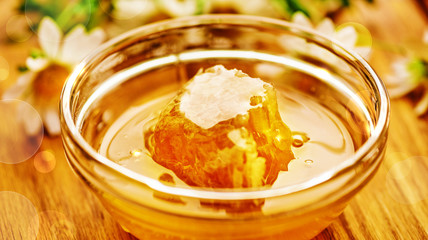 Honeycomb in glass bowl. Close-up of honey. Healthy organic. Sweet dessert background