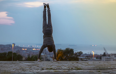 Man doing a handstand exercise during an outdoors