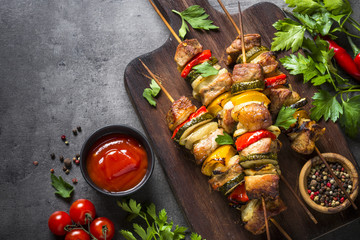 Grilled shish kebab with vegetables  on black.