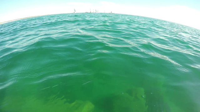 A diver above the water, watching and shooting competitions regatta yachts. Portugal Algarve