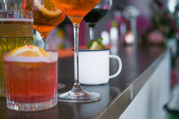 Several different smoothies in glasses of different shapes on the bar counter in the restaurant