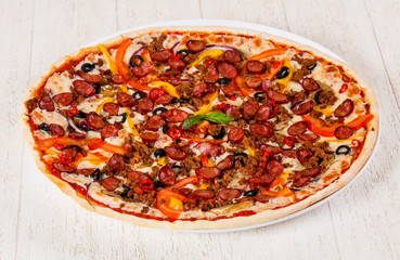 Pizza with sausages and minced meat