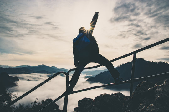 Man With Raised Hand On Top Of A Mountain, Concept Of Inspiration, Enthusiasm And Aspiration