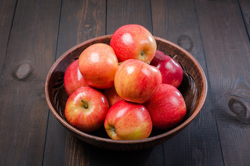 Red apples on a dark rustic background